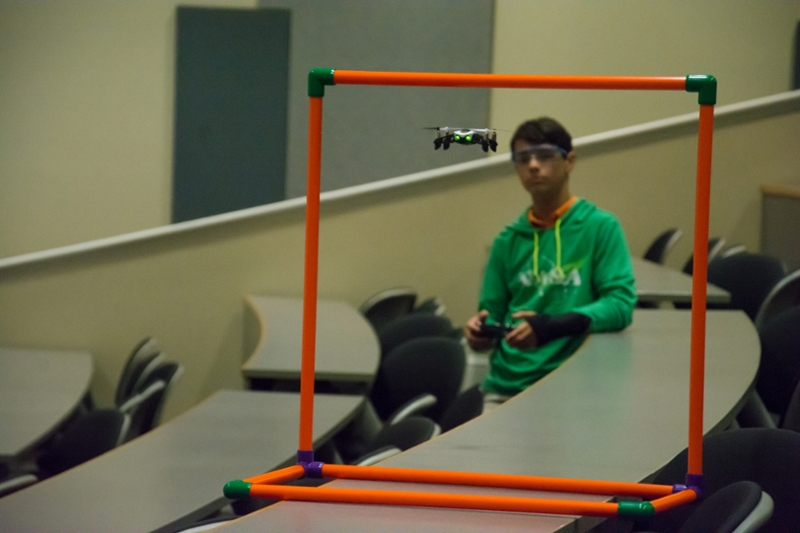Student controlling a remote-operated drone.